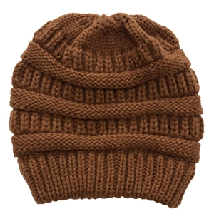 Close-up of thick knit texture on a dark brown winter thermal beanie for women