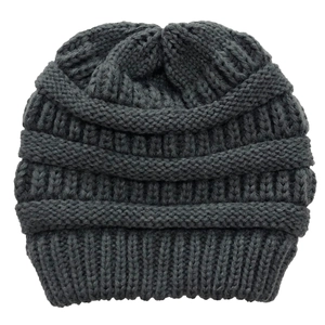 Detail shot of the thick cable knit texture and dark grey yarn on this winter beanie hat