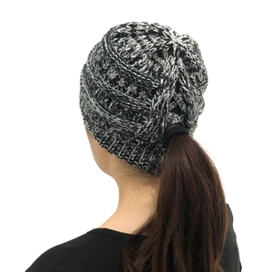 Detail view of the specialized ponytail hole design on this knit winter beanie