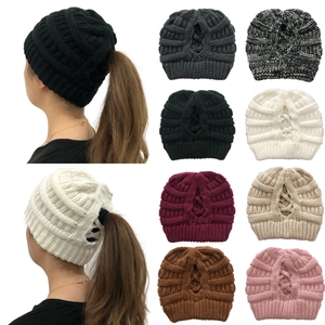 Close-up showing various colors and thick knitted texture of the ponytail beanie