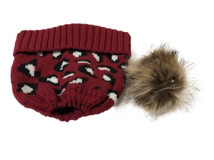 Detailed knit texture of red leopard print hat with fluffy brown faux fur pom pom accent