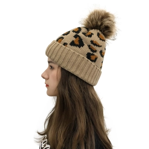Women's leopard print knit beanie with khaki faux fur pompom and ribbed cuff detail