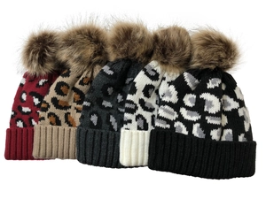 Detail showing five leopard print knit beanies with fluffy pom-poms in various colors