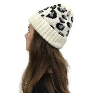 Detail view of leopard print knit beanie in cream showing side profile and texture
