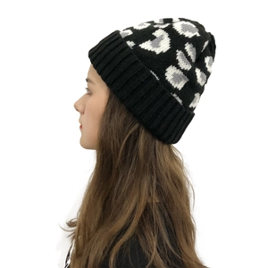 Close-up detail of leopard print knit beanie with high-quality texture and ribbed cuff