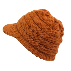 Detail showing thick knit texture and brim of the caramel winter hat for women