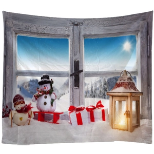 Winter Christmas tapestry featuring a snowman, warm lantern and snowy mountain window view