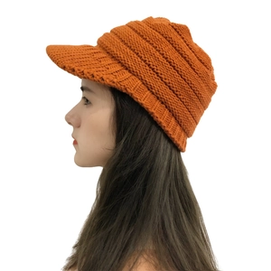 Women's orange chunky knit visor beanie hat with ear protection for winter outdoor warmth
