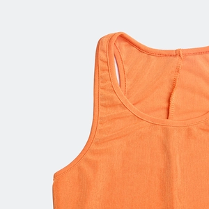 Detailed close-up of orange ribbed knit fabric showing the crew neckline and shoulder straps