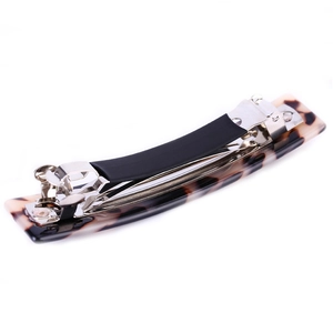 Detail of tortoiseshell acetate hair clip with silver metal spring and anti-slip rubber