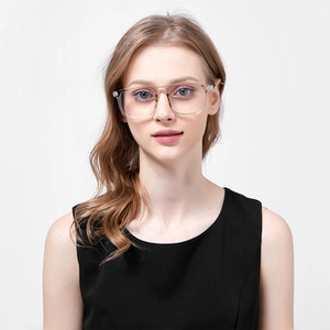 Close-up of clear round vintage glasses frame worn by a female model in a studio setting
