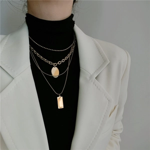Chic multi-layer gold titanium steel necklace with round and rectangular pendants on model