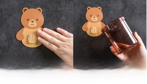 Detail showing installation of the brown bear wall-mounted bathroom cup holder adhesive