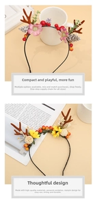Detailed view of handmade Christmas antler headband with berries, flowers and pine cones