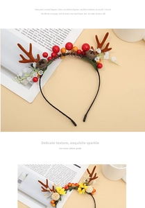 Detail of Christmas reindeer antlers headband with red berries and pine cones
