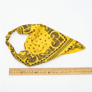 Yellow paisley turban headband with elastic band and wooden ruler measurement