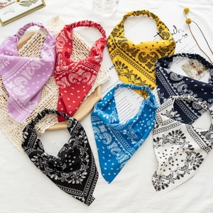 Detail of six paisley patterned elastic headbands in purple red yellow blue and black