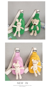 Detail view of colorful canvas kids chest bags featuring plush bunny and bear characters