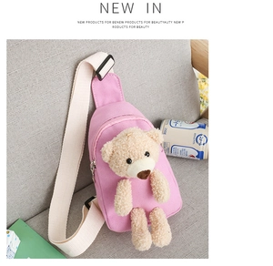 Detailed view of pink canvas chest bag with 3D teddy bear doll and adjustable strap