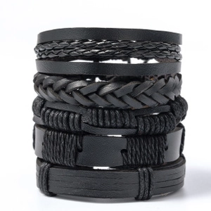Detailed view of multilayer black leather woven bracelets with mixed textures and cords