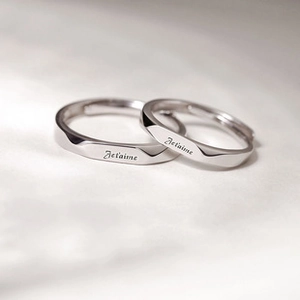Detail of silver couple rings with Je t'aime engraving for a romantic engagement gift