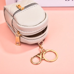 Mini PU leather coin purse in cream white with quilted stitching and gold zipper details