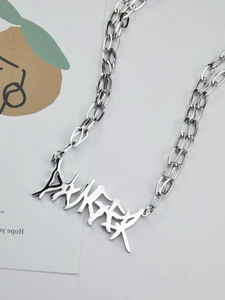 Detail shot of a silver gothic stainless steel chain featuring a DANGER letter pendant