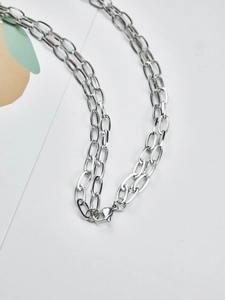 Detail of the silver oval link stainless steel chain with a secure lobster clasp closure