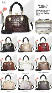 Detail view of crocodile pattern bag with crystal clasp and various color options