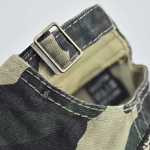 Detail of adjustable metal buckle and camouflage canvas strap on USA baseball cap