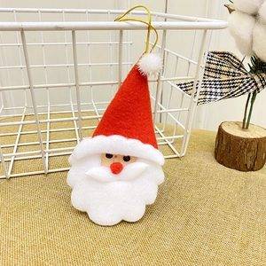 Plush Santa Claus ornament hanging on a basket for Christmas festive decoration