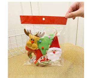 Detail view of handmade Christmas plush ornaments including Santa, Reindeer and Snowman