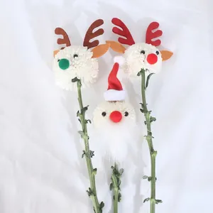 DIY Christmas floral toppers with cute reindeer pom poms and Santa Claus plush decorations