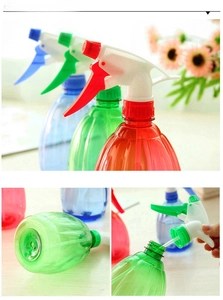 Detail view of colorful plastic spray bottles with textured vertical stripes and pump nozzle