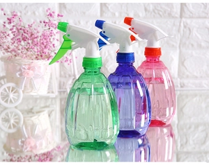 Three colorful plastic spray bottles with ribbed texture for garden watering and cleaning