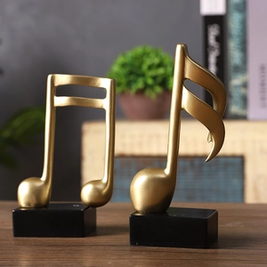 Modern gold resin music note sculpture with black base for minimalist home office decor