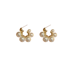 French vintage gold C-shaped hoop earrings with cluster imitation pearls on white background