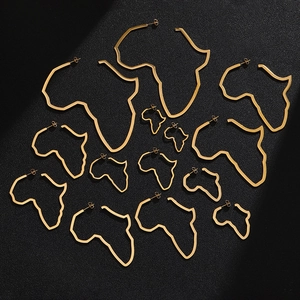 Detailed view of various sizes of gold stainless steel African map hoop earrings on dark background