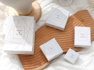 Detailed set of white marble pattern jewelry gift boxes and matching paper carry bag
