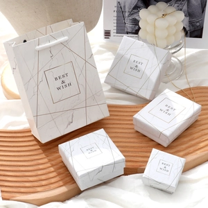 Detailed white marble jewelry gift boxes and bag set with elegant gold geometric patterns