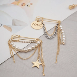 Golden and silver safety pin brooches with freshwater pearls, tassels and star pendant