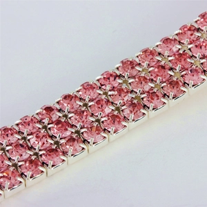 Macro close-up of pink four-row rhinestone pet collar with sparkling crystal details