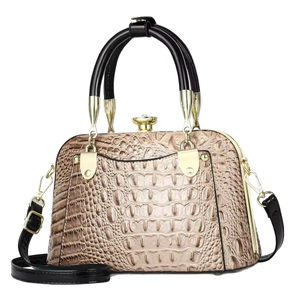 Elegant champagne crocodile embossed handbag with black handles and gold hardware
