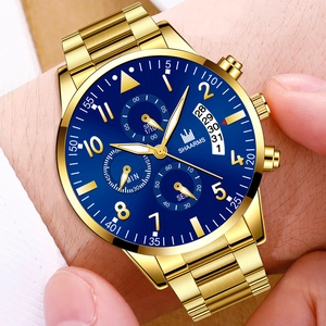 Men's business quartz watch with gold steel strap and blue dial on wrist