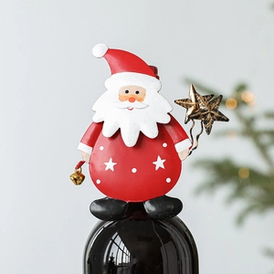 Christmas Santa Claus wine bottle topper with star and bell charms on dark bottle