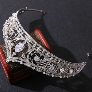 Silver bridal tiara with sparkling rhinestones and crystal centerpiece on wooden box