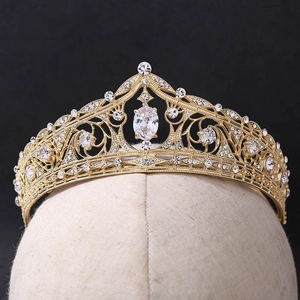 Elegant gold bridal tiara with sparkling clear crystals on mannequin head, black background