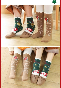 Detail von festlichen Korallenfleece Weihnachtssocken mit Weihnachtsmann und Zuckerstange