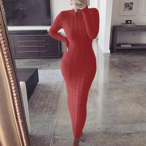 Detail shot of a red long sleeve cable knit dress showing thick weave pattern and texture
