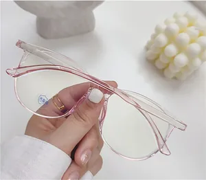 Detail of pink semi-transparent large frame glasses with blue light blocking lenses